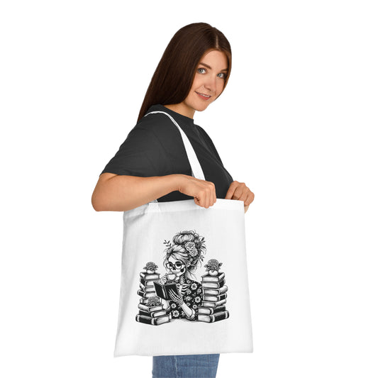 Skeleton reading a book tote bag